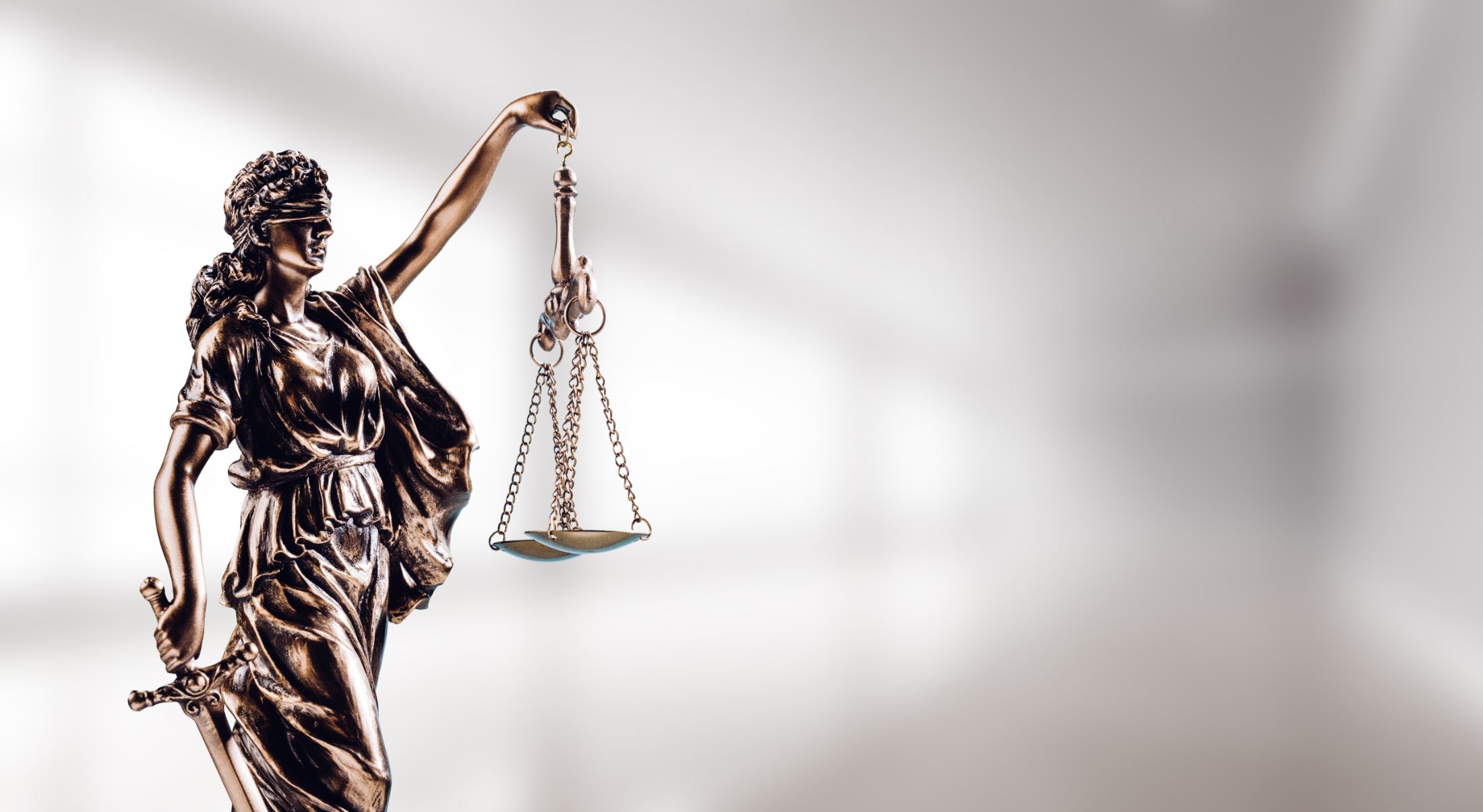 Bronze figure of Lady Justice holding scales